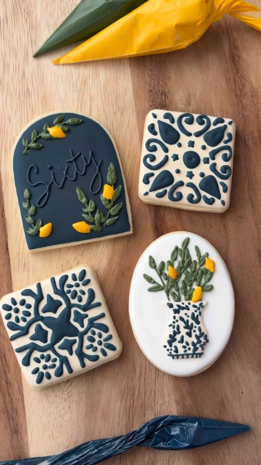 Navy and lemon cookies for a 60th, with tile patterns and a vase of lemons