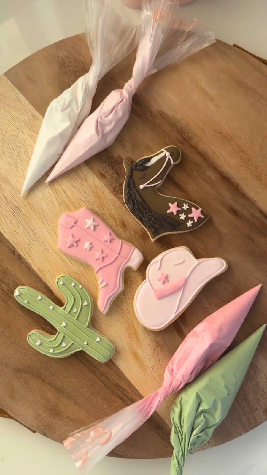 Cowgirl cookies with a hat, boots, a cactus, and a horse