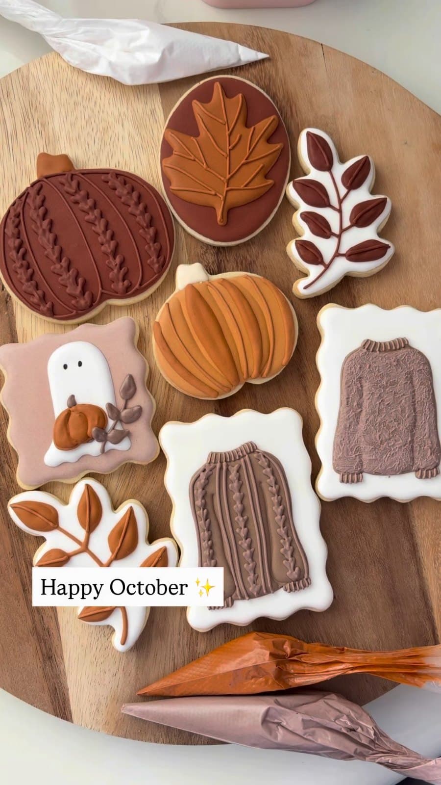 A full board of fall cookies, pumpkins, leaves, and a sweater